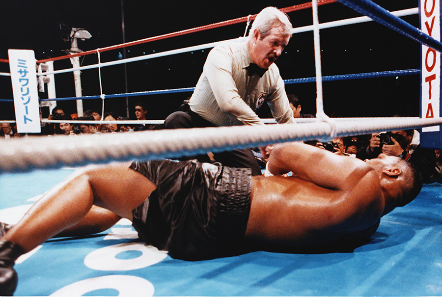 Referee Octavio Mayron counts as champion Mike Tyson is floored by Buster Douglas