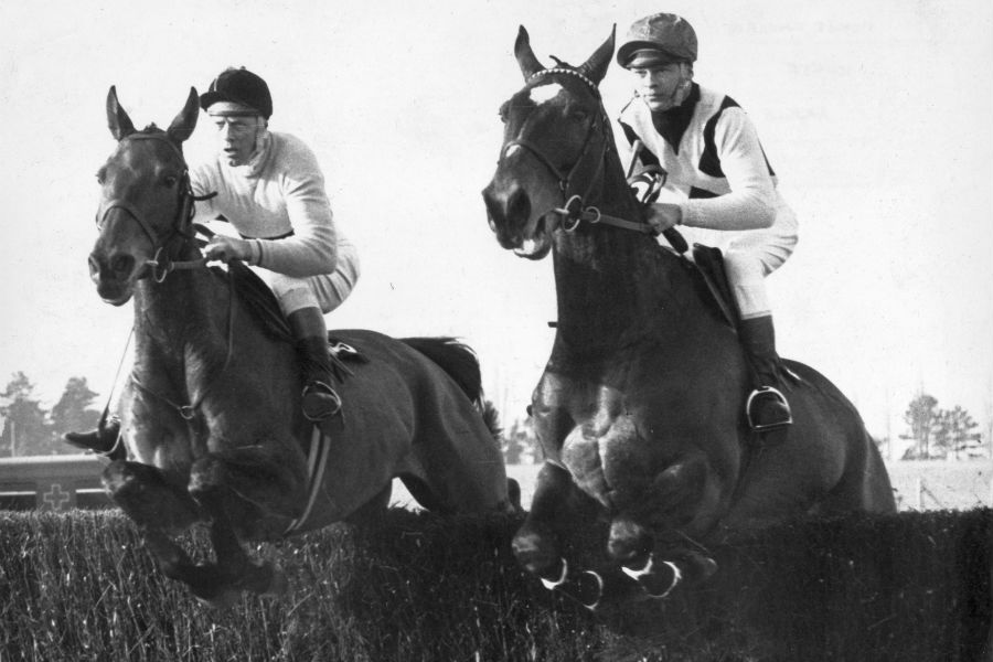 Arkle (left) and Mill House (right) jump the second face during the Cheltenham Gold Cup