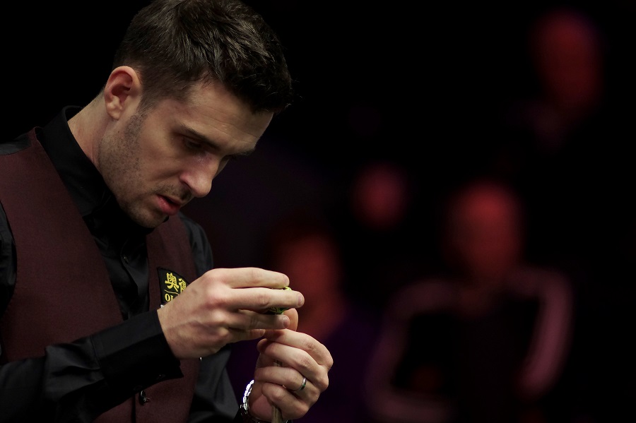 Mark Selby chalks his cue