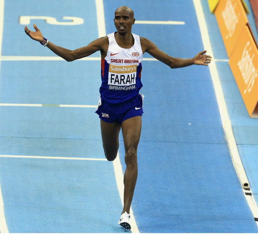 Mo Farah salutes the crowd as he crosses the finish line