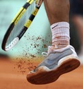 Rafael Nadal cleans his shoe