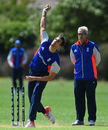 Steven Finn bowls as Peter Moores watches on