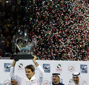 Roger Federer poses with the Dubai Tennis Championships trophy after defeating Novak Djokovic
