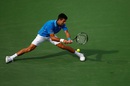 Novak Djokovic hits a backhand to Roger Federer