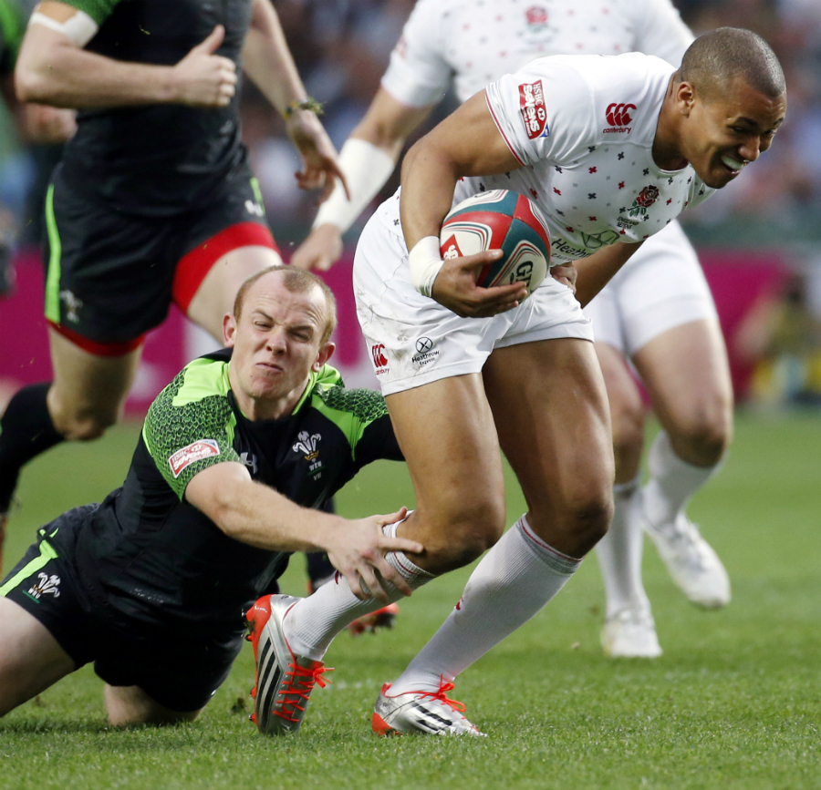 England's Marcus Watson is tackled by Dan Fish of Wales