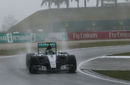 Nico Rosberg returns to the pits in heavy rain during Q2
