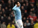 Carlos Tevez makes a point to Gary Neville