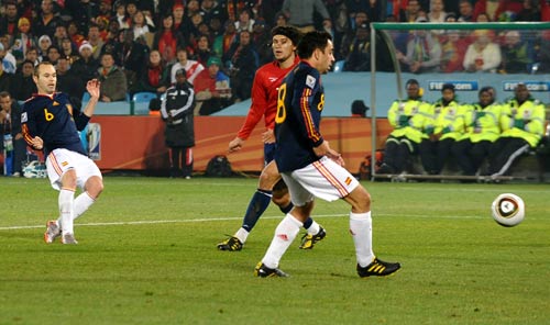 Andres Iniesta passes the ball into the net