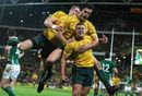 Australia's players enjoy themselves after Luke Burgess' try