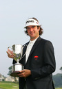 Bubba Watson holds the trophy after winning a three-way play-off