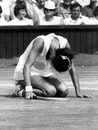 British tennis player Virginia Wade kneeling during a match